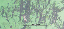 Figure 6. Photomicrograph showing high concentration of ferrous spheres (1,000x magnification) Figure 6. Photomicrograph showing high concentration of ferrous spheres (1,000x magnification)
