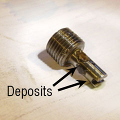 This orifice plug from a boiler feed pump turbine control has deposits covering the orifice holes. This orifice plug from a boiler feed pump turbine control has deposits covering the orifice holes.