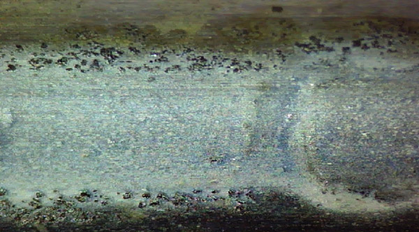 Damage to a centrifugal pump’s outboard bearing outer race was the result of dirty oil. Contaminants between the race and the rolling element made indentations in both the race and rolling element. Damage to a centrifugal pump’s outboard bearing outer race was the result of dirty oil. Contaminants between the race and the rolling element made indentations in both the race and rolling element.