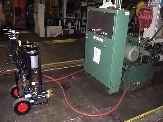 A flushing unit can be used to remove solid contaminants and water from the oil. A flushing unit can be used to remove solid contaminants and water from the oil.